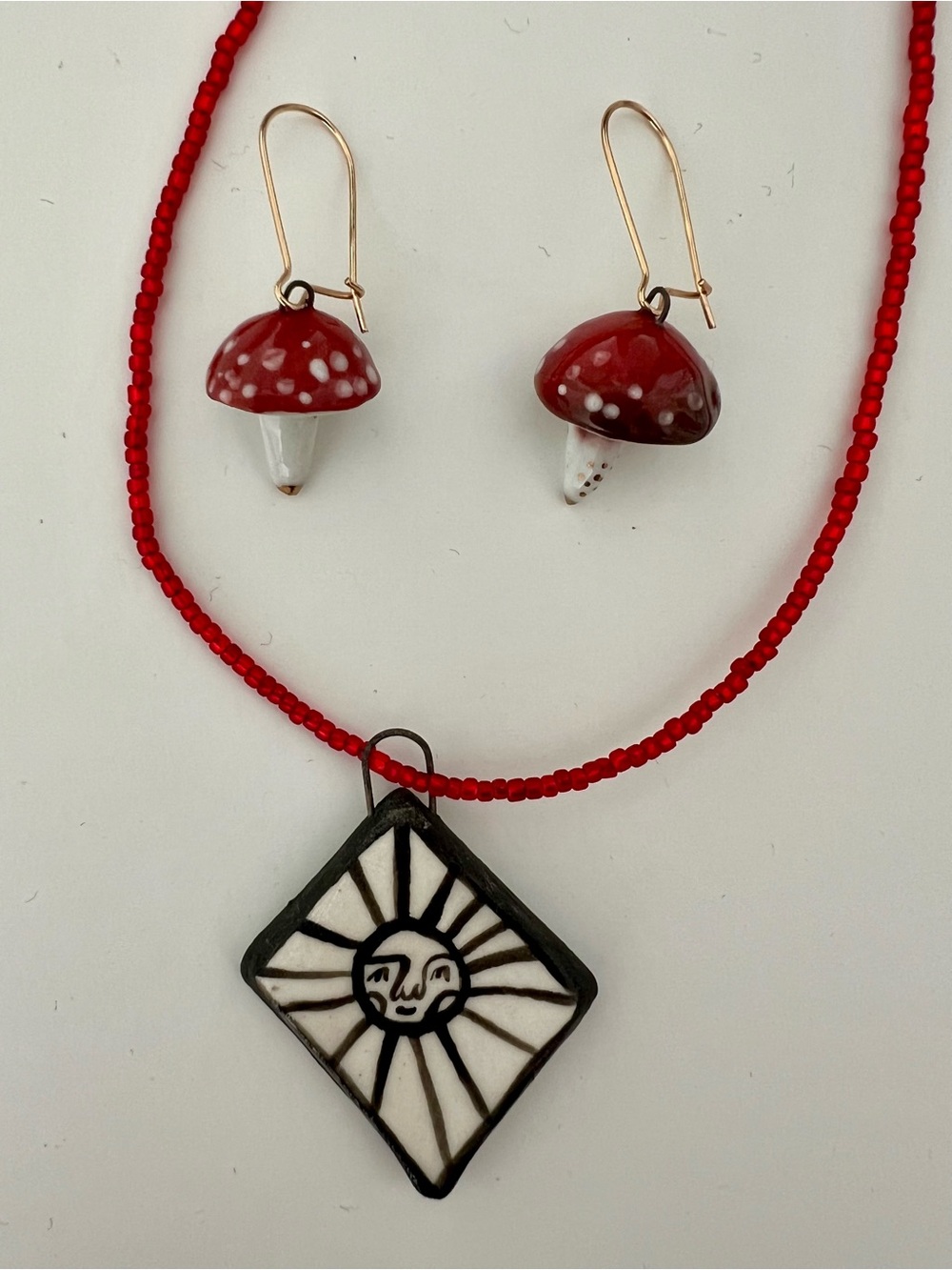 Handmade Red Beaded Necklace with Ceramic Sun Pendant and Red Mushroom Earrings
